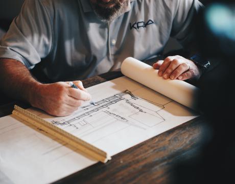 A man working on the design for a building.